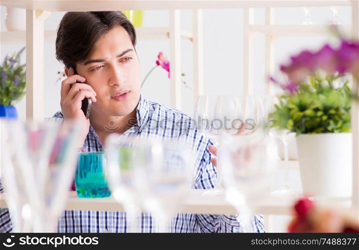 The man shopping in shop and calling his wife. Man shopping in shop and calling his wife