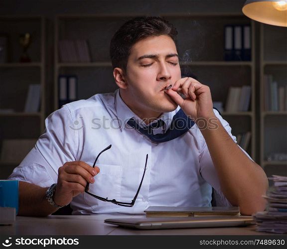 The man staying late at night and smoking marijuana. Man staying late at night and smoking marijuana
