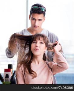 The man stylist working with woman in beauty salon. Man stylist working with woman in beauty salon