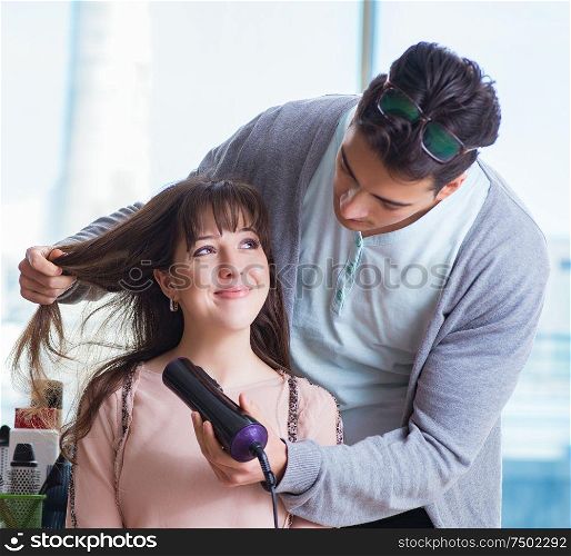 The man stylist working with woman in beauty salon. Man stylist working with woman in beauty salon