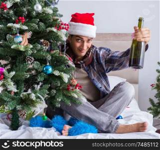 The man suffering hangover after christmas party. Man suffering hangover after christmas party