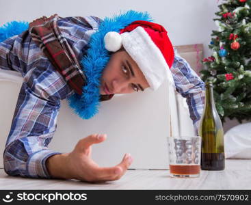 The man suffering hangover after christmas party. Man suffering hangover after christmas party