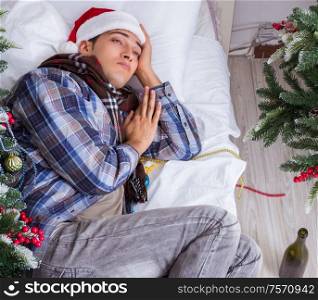 The man suffering hangover after christmas party. Man suffering hangover after christmas party