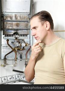 The man thinks of repair of a gas water heater