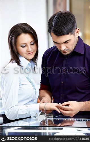 The man tries on a jeweller ring to the young girl