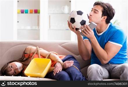 The man tying up his wife to watch sports football. Man tying up his wife to watch sports football