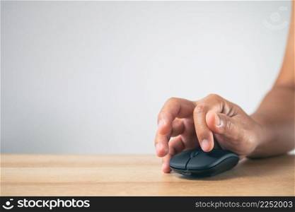 The man uses a mouse until his fingers pain. Office syndrome concept. Medium close up shot with copy space.