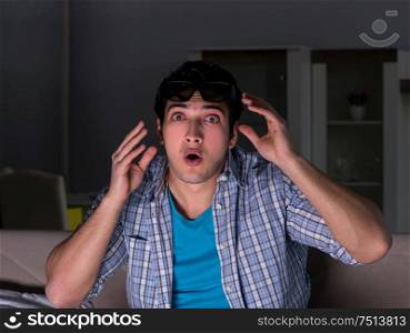 The man watching 3d television late at night. Man watching 3d television late at night