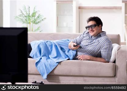 The man watching 3d tv at home. Man watching 3d tv at home