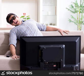 The man watching 3d tv at home. Man watching 3d tv at home