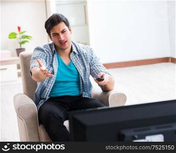 The man watching tv at home. Man watching tv at home