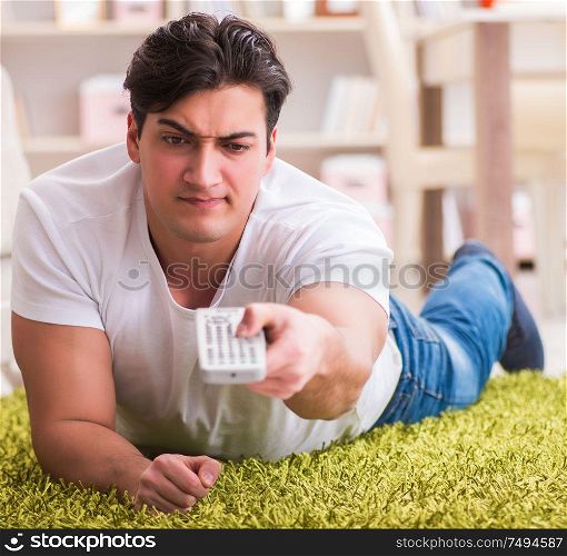 The man watching tv at home on floor. Man watching tv at home on floor