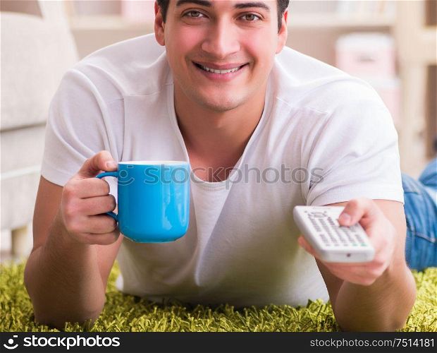 The man watching tv at home on floor. Man watching tv at home on floor