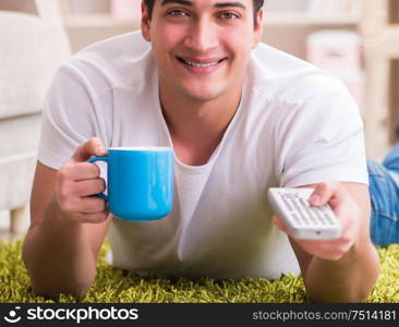 The man watching tv at home on floor. Man watching tv at home on floor