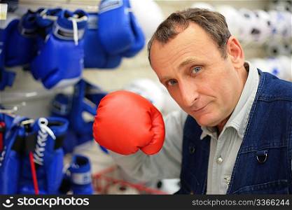 The man with a boxing glove in shop