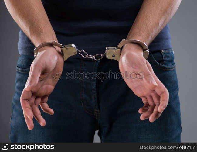 The man with his hands handcuffed in criminal concept. Man with his hands handcuffed in criminal concept