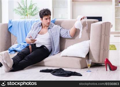 The man with mess at home after house party. Man with mess at home after house party