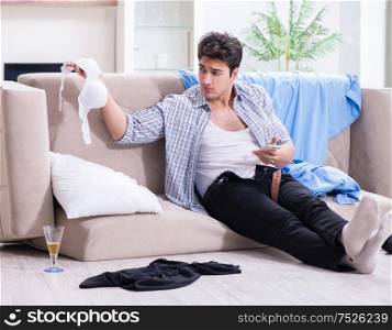 The man with mess at home after house party. Man with mess at home after house party