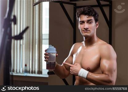 The man with nutrient supplements in sports gym. Man with nutrient supplements in sports gym