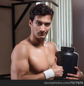 The man with nutrient supplements in sports gym. Man with nutrient supplements in sports gym