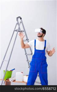 The man with vr glasses gluing wallpaper. Man with VR glasses gluing wallpaper