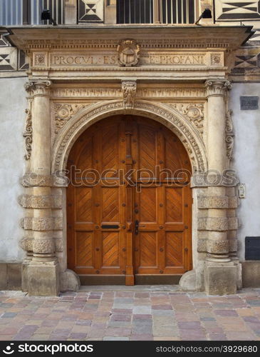 The massive portal of the medieval Deanery in the Old Town in the city of Krakow in Poland.