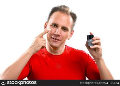 The mature well-groomed man cares of the appearance - applies a cream against wrinkles