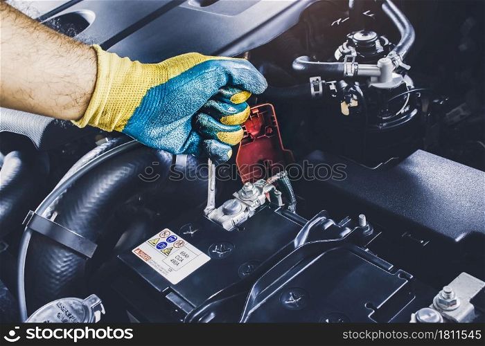 The Mechanic hand is fasten the bolt of battery Anode with the open-end wrench