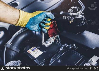The Mechanic hand is fasten the bolt of battery Anode with the open-end wrench