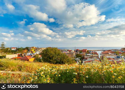 The medieval city with lighthouse in old harbour, aerial view from Schiavo Bastion in the evening, Crete, Greece