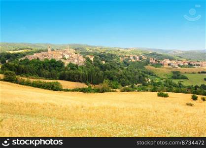 The Medieval Italian Town Surrounded By Forests And Plowed Fields