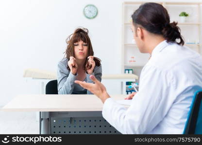 The mentally ill woman patient during doctor visit. Mentally ill woman patient during doctor visit