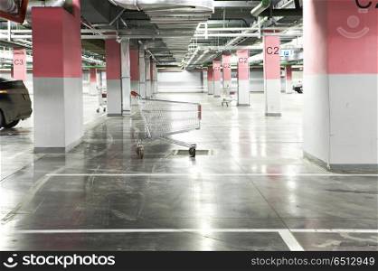 The metal cart in an empty underground parking. Underground parking