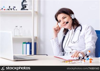 The middle-aged female doctor in telemedicine concept . Middle-aged female doctor in telemedicine concept