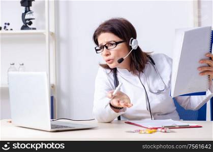 The middle-aged female doctor in telemedicine concept. Middle-aged female doctor in telemedicine concept