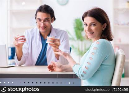 The middle-aged woman visiting male doctor stomatologist. Middle-aged woman visiting male doctor stomatologist