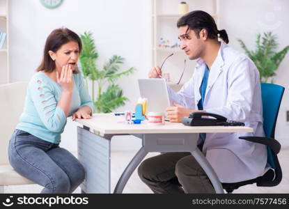 The middle-aged woman visiting male doctor stomatologist. Middle-aged woman visiting male doctor stomatologist