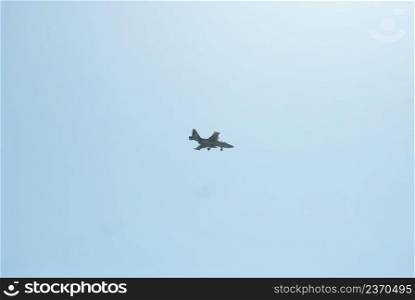 The military fighter released the landing gear to perform a landing.