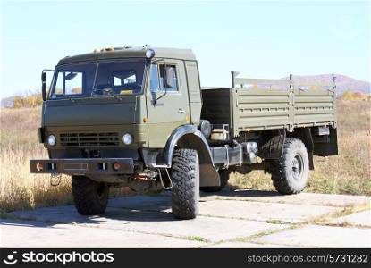 The military lorry with a color body khaki and the big wheels