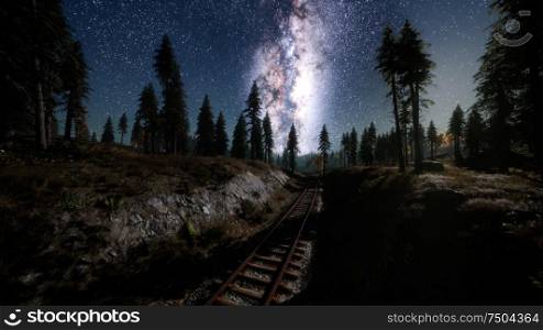 The milky way above the railway and forest