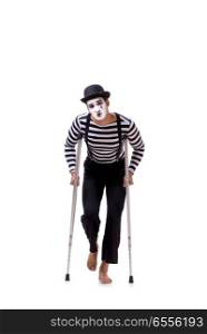 The mime with crutches isolated on white background. Mime with crutches isolated on white background