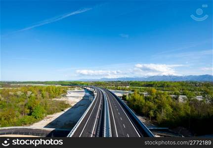 The Modern Highway in Piedmont on the Background of Snow-capped Alps, Italy