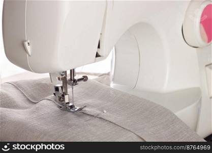 The modern sewing machine and item of clothing. sewing process.. The modern sewing machine and item of clothing