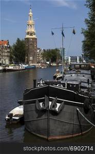 The Montelbaanstoren, a tower on banks of the Oudeschans Canal in Amsterdam in the Netherlands. It was originally part of the city walls and dates from 1516. The tower is 48m high.