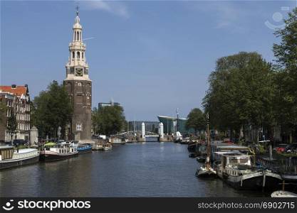 The Montelbaanstoren, a tower on banks of the Oudeschans Canal in Amsterdam in the Netherlands. It was originally part of the city walls and dates from 1516. The tower is 48m high.
