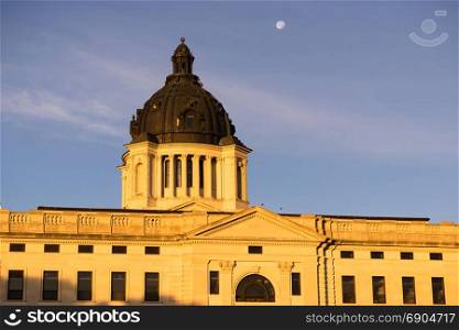 The moon shines behind the capitol dome in Pierre, SD
