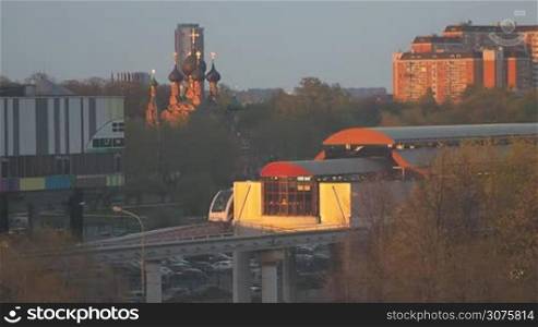 The Moscow monorail train in the area of Ostankino TV center. Leaving the station at sunset. Not processed the original video from the camera.