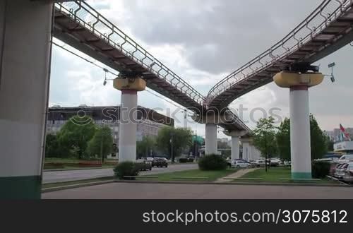 The Moscow monorail train in the area of Ostankino TV center. Departs from the station. The view from below. Cloudy.