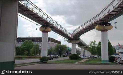 The Moscow monorail train in the area of Ostankino TV center. Departs from the station. The view from below. Cloudy.