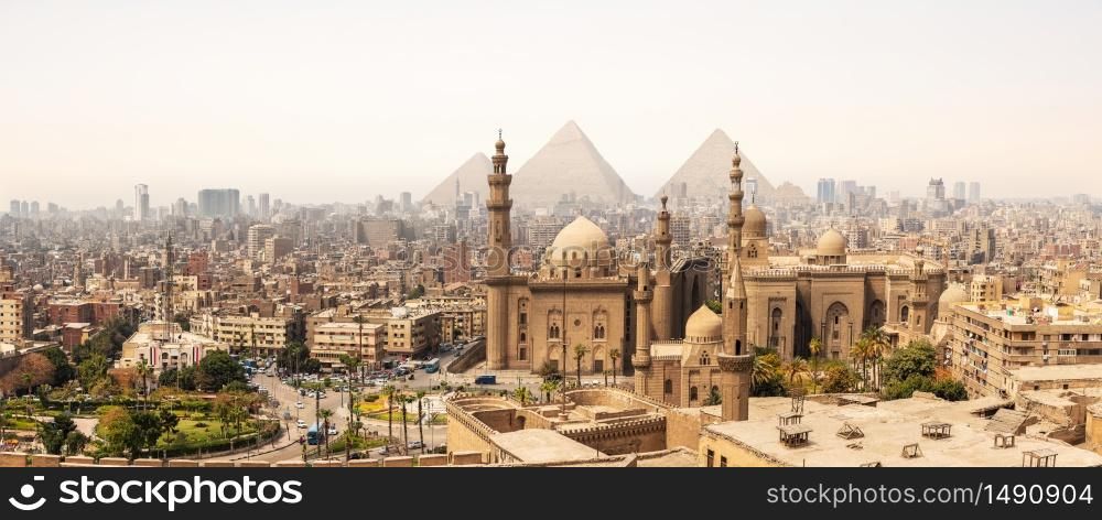 The Mosque-Madrassa of Sultan Hassan In front of the Giza Pyramids, Cairo, Egypt.